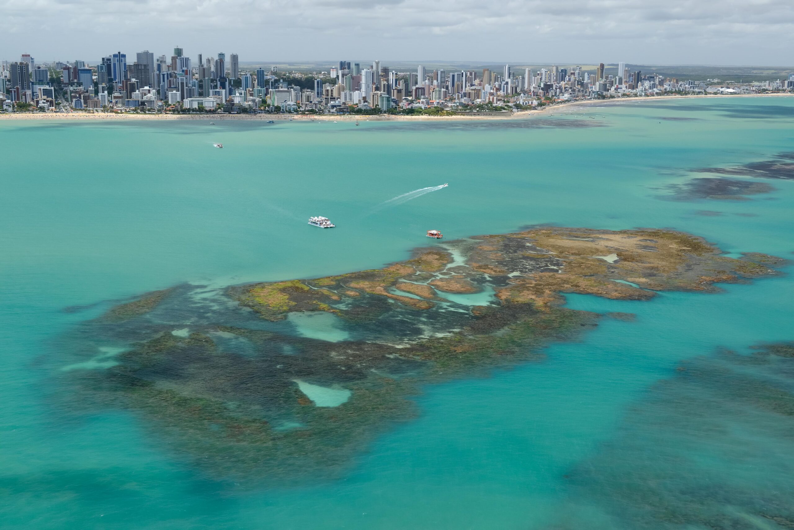 João Pessoa, Paraíba, Brazil on November 15, 2012. Aerial view of the emerald-colored sea and natural reefs, known as Picaozinho, which appears in the low tide.